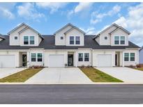 Charming townhomes featuring attached garages, crisp white siding, and well-maintained landscaping at 564 Sea Sparrow St. # 564, Myrtle Beach, SC 29588