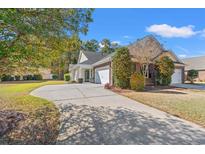 Charming single Gathering home featuring a brick facade, attached garage and a concrete driveway at 570 Botany Loop Murrells Inlet # 570, Murrells Inlet, SC 29576