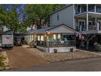 Charming single-story home with a covered porch and a driveway with a trailer parked outside at 6001 - 5010 S Kings Hwy., Myrtle Beach, SC 29575