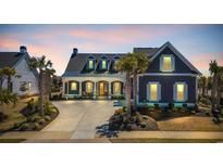 Charming home with manicured lawn, and concrete driveway, perfect for coastal living at 6121 Bolsena Place, Myrtle Beach, SC 29572