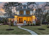 Charming two-story home with inviting front porch, manicured lawn, and beautiful landscaping at 644 Whispering Pines Ct., Murrells Inlet, SC 29576