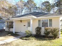 Cozy single-story home with a covered front porch, neatly trimmed shrubs, and a well-maintained yard at 6654 Wisteria Dr., Myrtle Beach, SC 29588