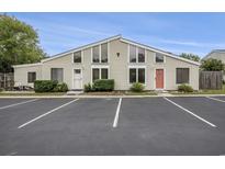 Inviting two-story condo featuring large windows, paired entrances, and dedicated parking spaces at 800 9Th Ave. S # T3, North Myrtle Beach, SC 29582
