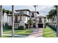 A stunning multi-story white home featuring a driveway, lush landscaping, and dark trim accents at 918 Strand Ave., North Myrtle Beach, SC 29582