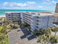 Spacious condo building featuring palm trees, a large parking lot, and ocean views at 9580 Shore Dr. # 311, Myrtle Beach, SC 29572