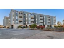 Three-story condo building with blue siding and neatly maintained landscaping at 1101 Possum Trot Rd. # C-303, North Myrtle Beach, SC 29582