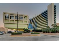 Inviting exterior of Coral Beach Resort featuring lush landscaping and convenient parking at 1105 S Ocean Blvd. # 1224, Myrtle Beach, SC 29577
