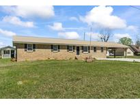 Charming brick ranch home featuring a metal roof and a convenient covered carport on a spacious lot at 1136 Knotty Branch Rd., Conway, SC 29527