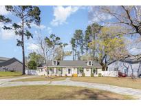 Charming single story home featuring a spacious front yard, rocking chair porch, and inviting curb appeal at 150 Brookgate Dr., Myrtle Beach, SC 29579