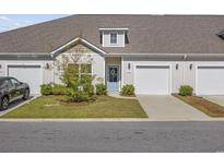 Charming townhome featuring a well-maintained lawn, front door wreath, and an attached one car garage at 154 Sea Shell Dr. # 16, Murrells Inlet, SC 29576