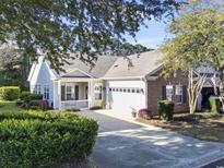 Charming single-story home featuring a well-manicured lawn and inviting front porch at 173 Knight Circle # 1, Pawleys Island, SC 29585