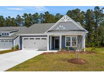 Charming single-story home with a two-car garage, a gray exterior, and landscaped front yard at 2191 Gooseberry Way, Longs, SC 29568