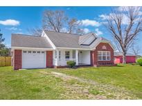 Charming brick home featuring a garage, covered porch, and well-maintained landscaping at 2965 Mount Olive Rd., Loris, SC 29569