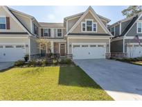 Charming two-story home with a manicured lawn and a two-car garage offers great curb appeal at 341 Golan Circle # B, Myrtle Beach, SC 29579