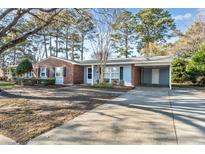 Charming single-story home with brick accents, a carport, and a spacious front yard at 3494 Cactus St. # 3494, Myrtle Beach, SC 29577