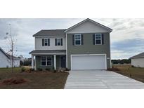 Charming two-story home with a two-car garage, neutral siding, and well-manicured lawn at 414 Acosta Circle, Conway, SC 29527