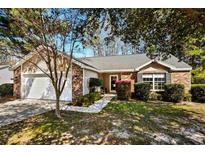 Charming single-story home with brick and siding, featuring a well-maintained front yard and attached garage at 4195 Wrens Crossing, Little River, SC 29566