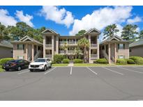 Inviting condo complex with multiple levels, tidy landscaping, and ample parking for residents and guests at 45 Pinehurst Ln. # 2G, Pawleys Island, SC 29585