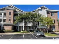 Attractive condominium exterior with well-maintained landscaping and ample parking at 4865 Magnolia Pointe Ln. # 204, Myrtle Beach, SC 29577