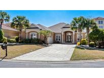 Charming single-story home featuring lush tropical landscaping and a spacious driveway at 6005 Fish Hawk Ct., Myrtle Beach, SC 29579