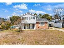 Charming two-story home featuring white siding, brick accents, and a well-manicured front yard at 806 Duncan Ave., Myrtle Beach, SC 29572