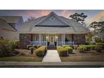 Charming single-story home with brick accents, covered front porch, and manicured landscaping at 820 Morrall Dr., North Myrtle Beach, SC 29582