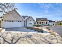 Charming home featuring an attached garage, manicured lawn, and beautiful curb appeal on a sunny day at 9648 Bradford Ln., Murrells Inlet, SC 29576