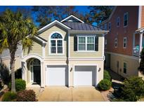 Charming home with a two-car garage, and a striking architectural design and inviting curb appeal at 408 7Th Ave. S, North Myrtle Beach, SC 29582