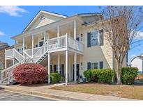 Charming condo with private balconies, lush landscaping, and traditional architectural details at 5022 Belleglen Ct. # 202, Myrtle Beach, SC 29579