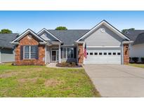 Charming single-story home featuring a brick facade, inviting entrance, and attached two-car garage at 542 Sand Ridge Rd., Conway, SC 29526