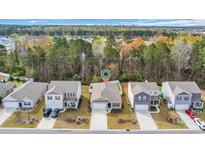 Beautiful aerial view of a neighborhood showcasing well-maintained homes and lush greenery at 1016 Laurens Mill Dr., Myrtle Beach, SC 29579