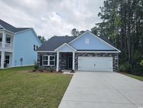 Charming single-story home featuring stone accents, a two-car garage and well-maintained landscaping at 1848 Seachase Way, North Myrtle Beach, SC 29582