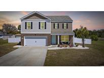 Charming two-story home with a well-manicured lawn, brick accents, and a cozy front porch at 206 Math Place, Longs, SC 29568