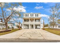 Beautiful two-story stilt home with a spacious driveway and double balconies, perfect for beach living at 318 Vista Dr., Murrells Inlet, SC 29576