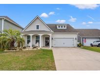 Charming single-story home with a manicured lawn and a welcoming front porch with decorative columns at 1210 Harbison Circle, Myrtle Beach, SC 29579