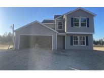 Charming two-story home showcasing gray siding, black shutters, and an attached two-car garage at 1490 Hardwick Rd., Conway, SC 29526