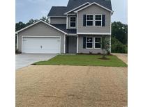 Charming two-story home featuring a gray exterior with a white garage door and a well-manicured lawn at 1490 Hardwick Rd., Conway, SC 29526