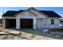 Unfinished home featuring a two-car garage, Tyvek weather barrier and black roof at 1506 Hardwick Rd., Conway, SC 29526