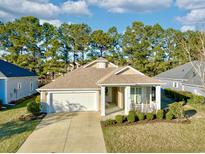 Charming single-story home featuring a well-manicured lawn, attached two car garage, and a cozy front porch at 1652 Murrell Pl., Murrells Inlet, SC 29576