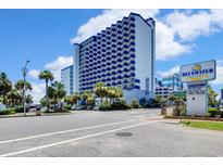 Beautiful exterior view of the Bluewater Resort building on a sunny day with a blue sky at 2001 S Ocean Blvd. # 720, Myrtle Beach, SC 29577