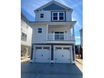 Charming two-story home with a balcony and a two-car garage featuring white doors at 201-E Madison Ct., Myrtle Beach, SC 29577