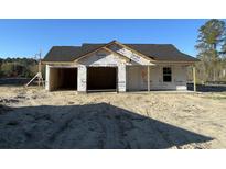 Under-construction home featuring a two car garage, newly installed black roof, and Tyvek home wrap ready for siding at 2247 Society Dr., Conway, SC 29527