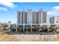 Stunning exterior of a light blue condo resort with palm trees and a convenient drive-through at 2401 S Ocean Blvd. # 259, Myrtle Beach, SC 29577