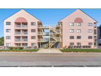 Exterior view of condo buildings with access stairs and walkway over the driveway at 2710 S Ocean Blvd. # 407-A, Myrtle Beach, SC 29577
