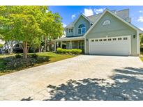 Inviting home featuring a lush yard, a spacious driveway, and an attached two-car garage at 4025 Captiva Row, Myrtle Beach, SC 29579