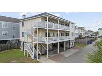 Desirable home with multi-level balconies, beautiful paint, and lovely landscaping at 412 Seaside Dr. S, Surfside Beach, SC 29575