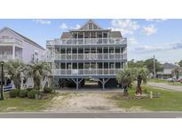 Three story beach house on stilts features multiple decks and covered parking at 510 S Ocean Blvd., Surfside Beach, SC 29575