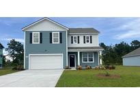 Charming two-story home with blue siding, white garage door, and well-maintained front yard at 5152 Yellowstone Dr., Conway, SC 29526