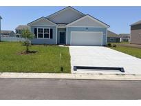 Charming one-story home with a two-car garage and well-manicured lawn in a suburban neighborhood at 5163 Yellowstone Dr., Conway, SC 29526