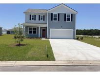 Charming two-story home with blue siding, a spacious driveway, and manicured lawn at 5179 Yellowstone Dr., Conway, SC 29526